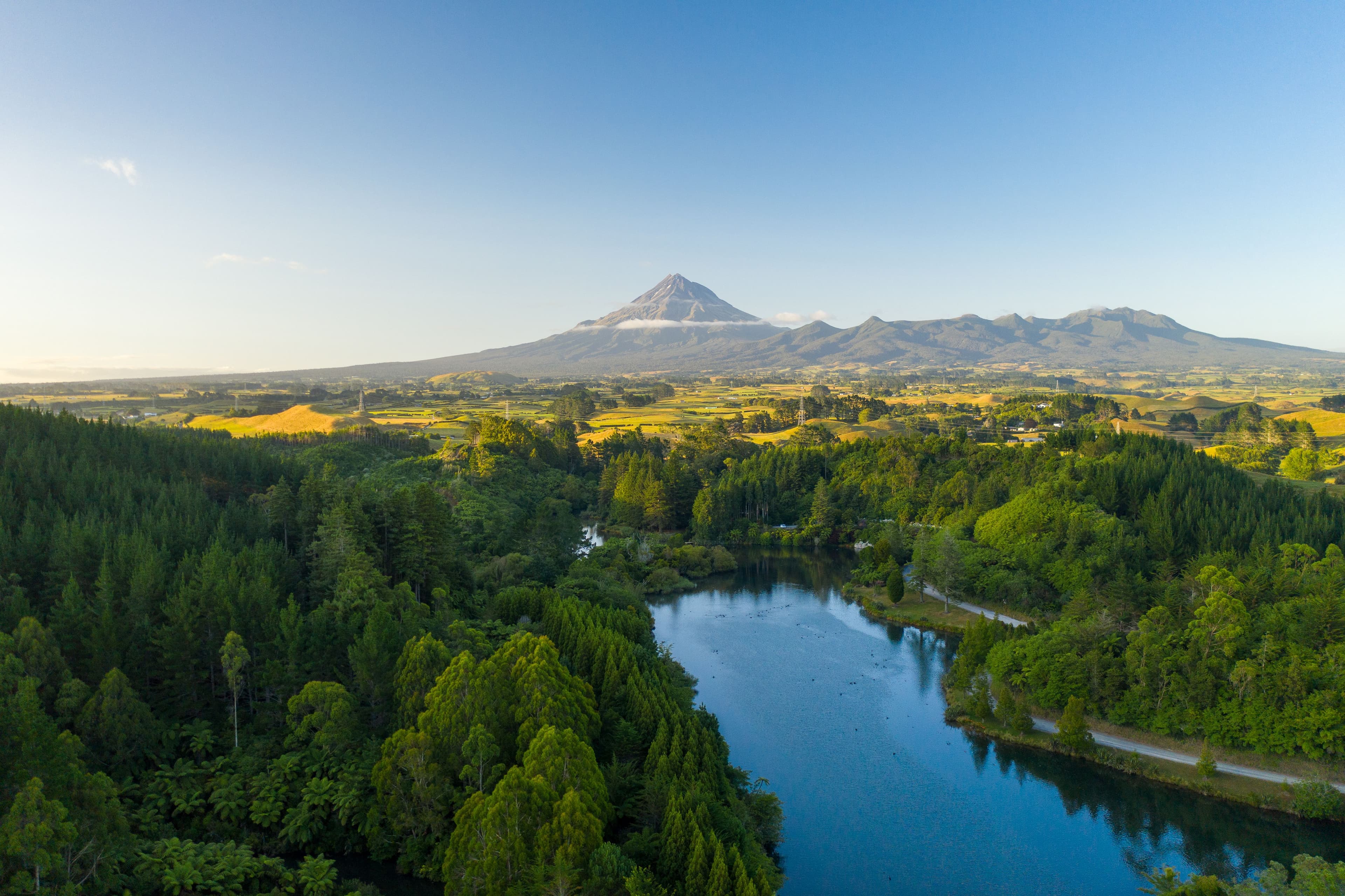 Maunga Taranaki rising over ngahere and awa